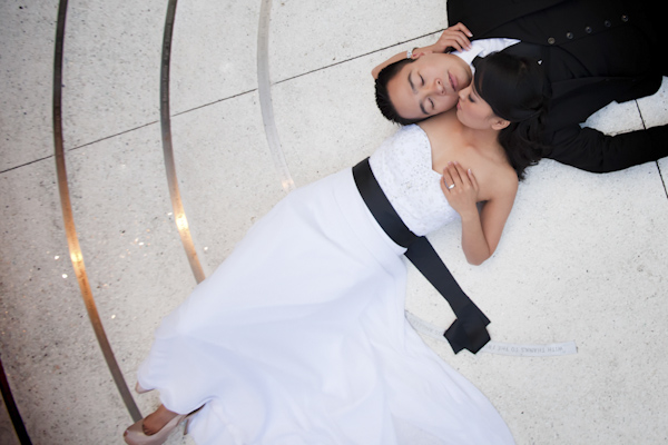 the newlywed laying on the ground cuddling - wedding photo by top Orange County, California wedding photographers D. Park Photography